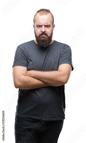 Young caucasian hipster man over isolated background skeptic and nervous, disapproving expression on face with crossed arms. Negative person.