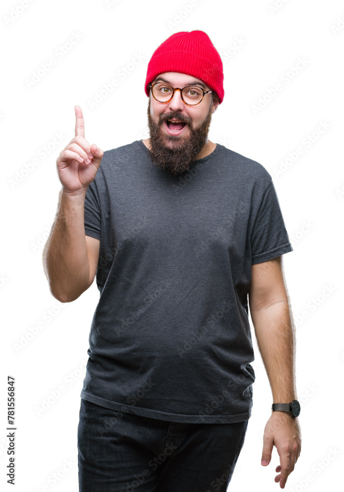 Young caucasian hipster man wearing glasses over isolated background pointing finger up with successful idea. Exited and happy. Number one. Young caucasian hipster man wearing glasses over isolated background pointing finger up with successful idea. Exited and happy. Number one.