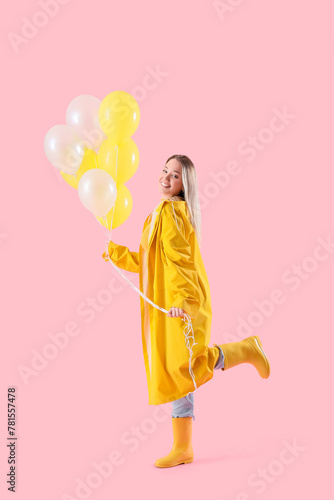 Young woman in raincoat wit...