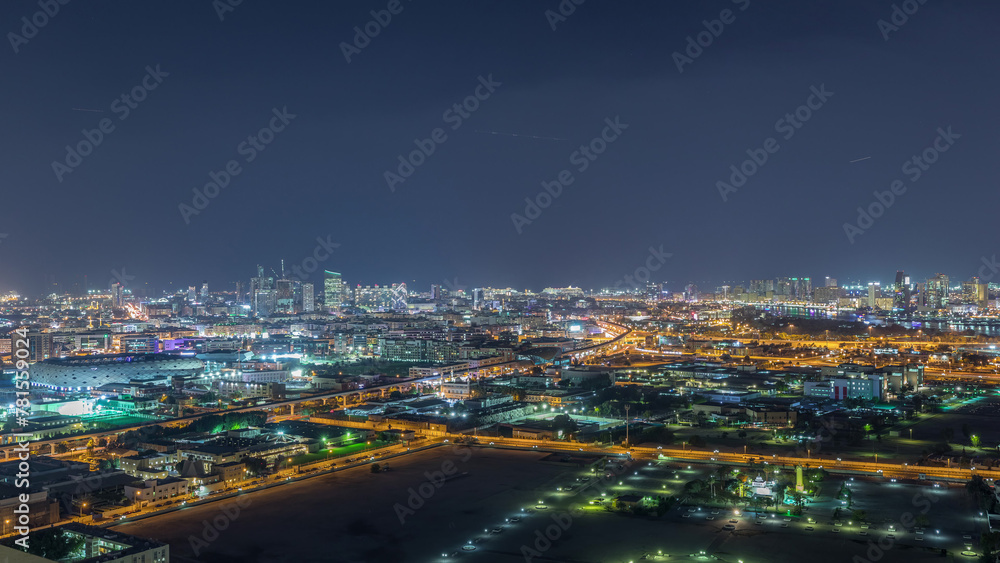 The rhythm of the city at night with illuminated road in Dubai near canal aerial timelapse