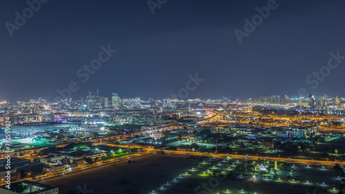 The rhythm of the city at night with illuminated road in Dubai near canal aerial timelapse © neiezhmakov