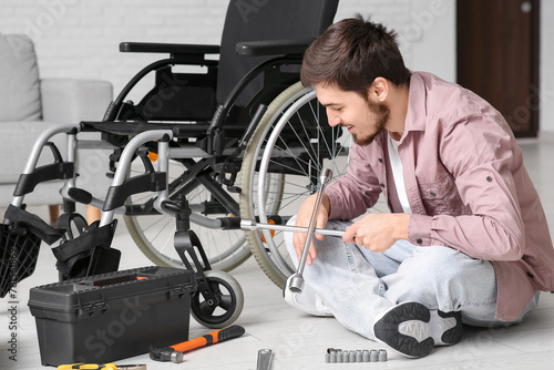 Young man with cross wrench...