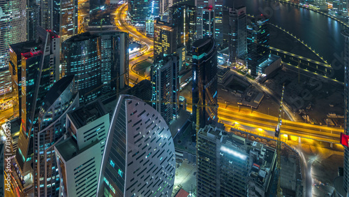 Panoramic aerial view of business bay towers in Dubai night timelapse.