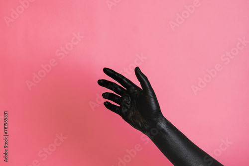 Gesticulation of black painted elegant woman's hand on her skin. High Fashion art concept