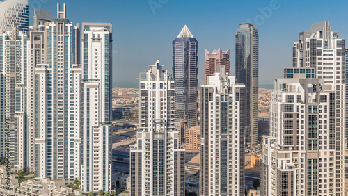 Modern residential and office complex with many towers aerial timelapse at Business Bay  Dubai  UAE.