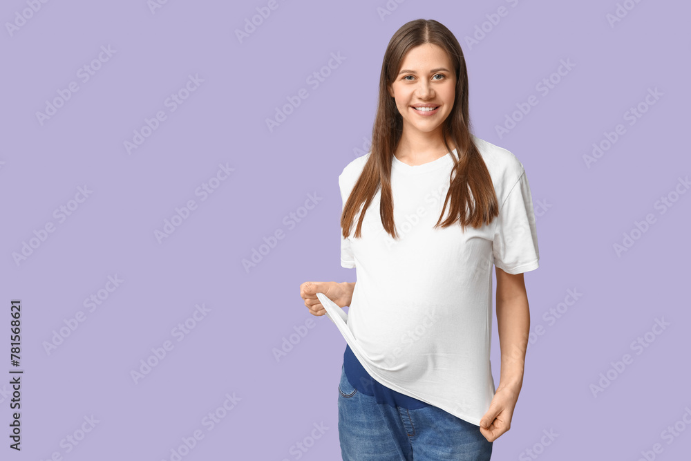 Beautiful young pregnant woman in stylish white t-shirt on lilac background Beautiful young pregnant woman in stylish white t-shirt on lilac background