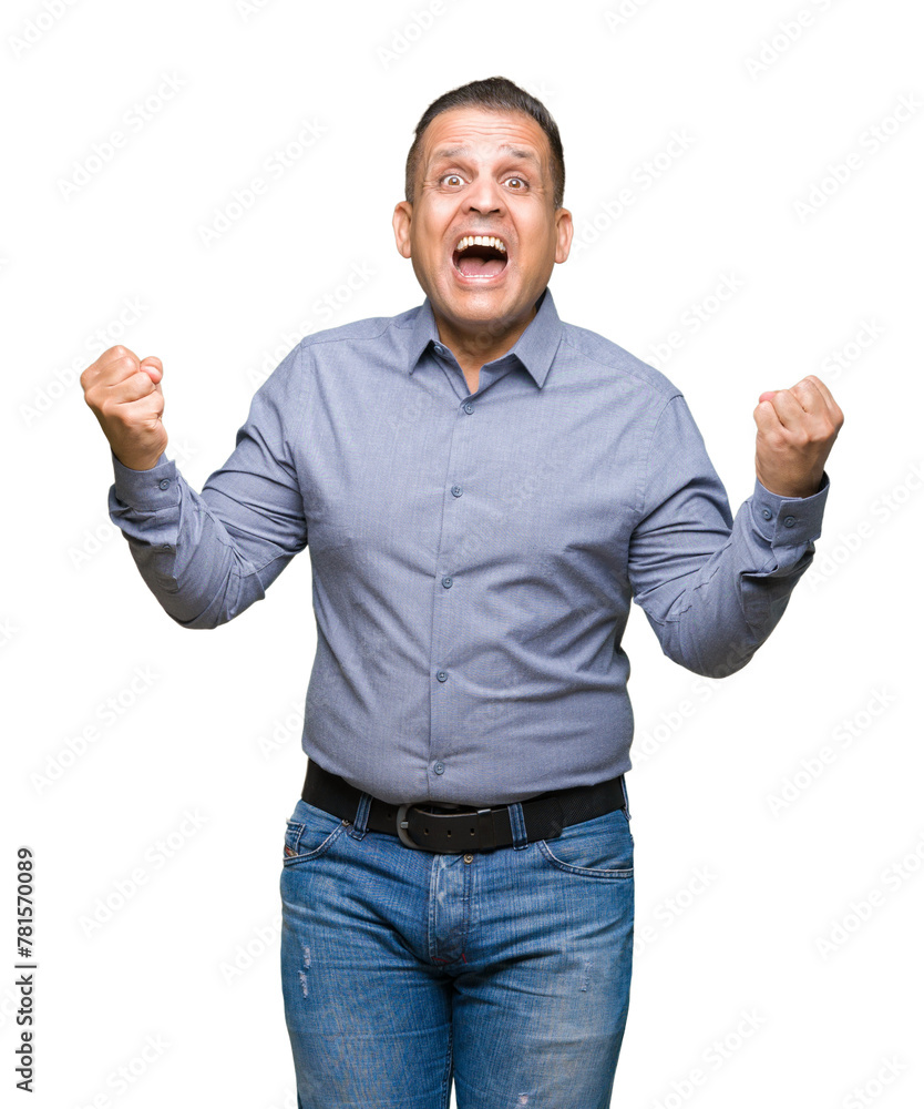 Fototapeta premium Middle age arab business man over isolated background celebrating surprised and amazed for success with arms raised and open eyes. Winner concept.