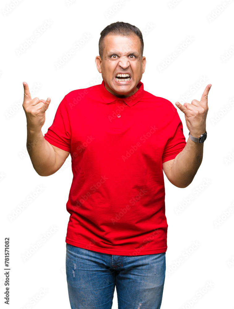 Middle age arab man over isolated background shouting with crazy expression doing rock symbol with hands up. Music star. Heavy concept. Middle age arab man over isolated background shouting with crazy expression doing rock symbol with hands up. Music star. Heavy concept.