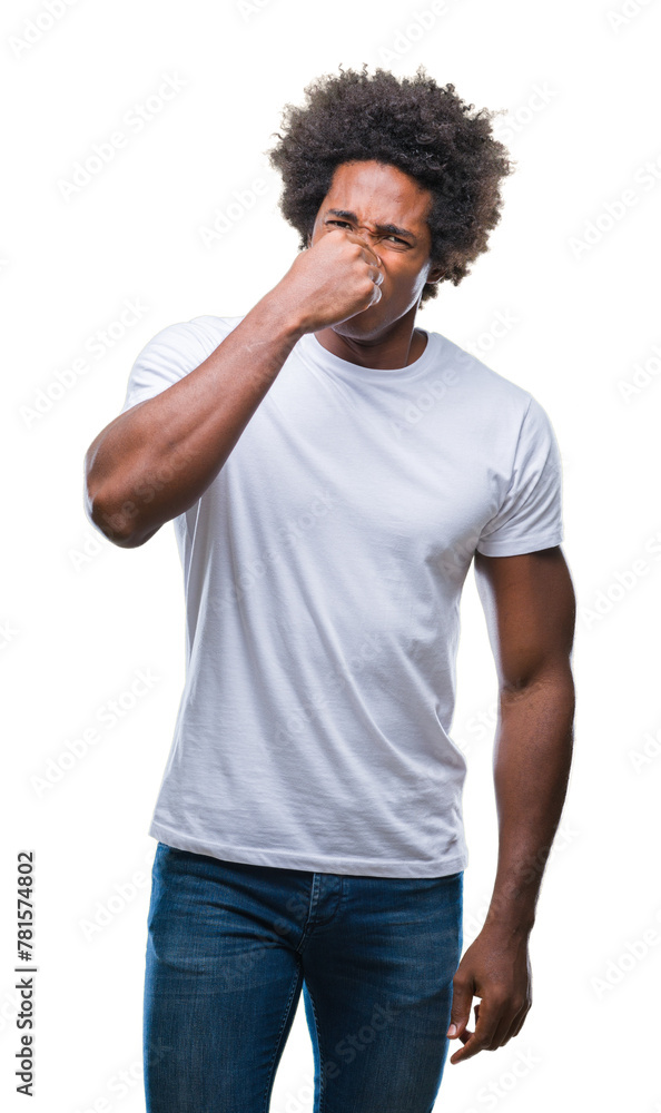 Afro american man over isolated background smelling something stinky and disgusting, intolerable smell, holding breath with fingers on nose. Bad smells concept. Afro american man over isolated background smelling something stinky and disgusting, intolerable smell, holding breath with fingers on nose. Bad smells concept.