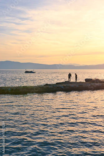 Lake Ohrid, North Macedonia, Spring, Sunset, April 09 2024. Mountain range and peninsula in distance. Ohrid Lake, Macedonia, Europe.The clear mesmerizing waters of lake Ohrid with beautiful view. 