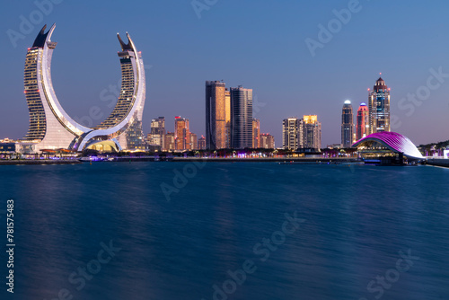 Crescent tower from Al Maha Island in Qatar, with a brightly blue sky before sunset . Lusail, Qatar