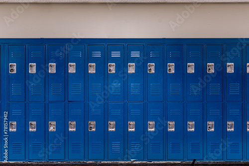 Empty school hallway with blue metal student lockers	