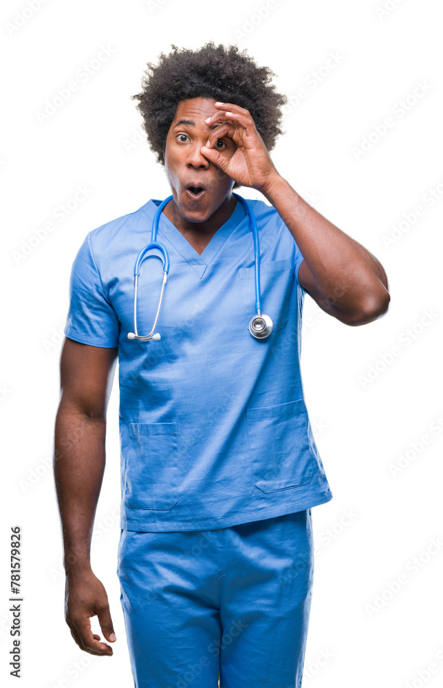 Afro american surgeon doctor man over isolated background doing ok gesture shocked with surprised face, eye looking through fingers. Unbelieving expression. Afro american surgeon doctor man over isolated background doing ok gesture shocked with surprised face, eye looking through fingers. Unbelieving expression.