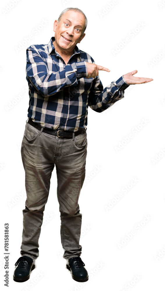 Handsome senior man wearing casual shirt amazed and smiling to the camera while presenting with hand and pointing with finger. Handsome senior man wearing casual shirt amazed and smiling to the camera while presenting with hand and pointing with finger.