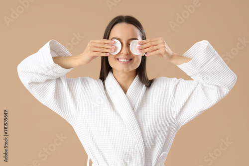 Young woman in bathrobe wit...