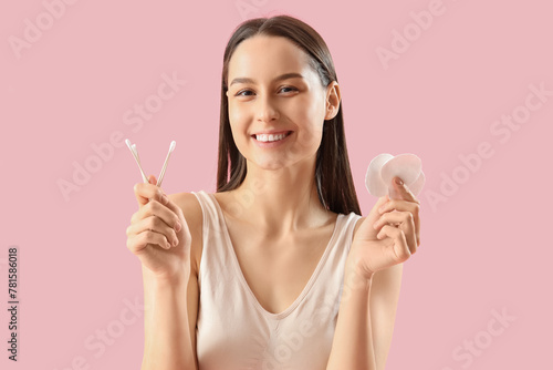 Young woman with cotton pad...