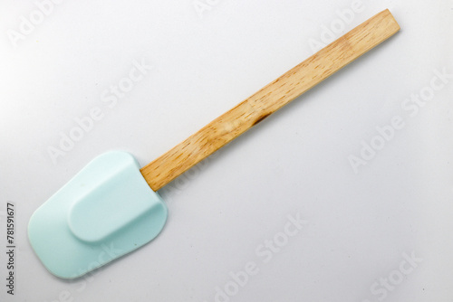 Wooden tablespoon with silicone head. White background.