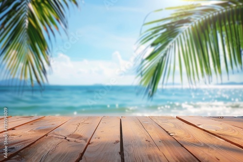 View of a tropical beach from a wooden deck with palm leaves in the foreground