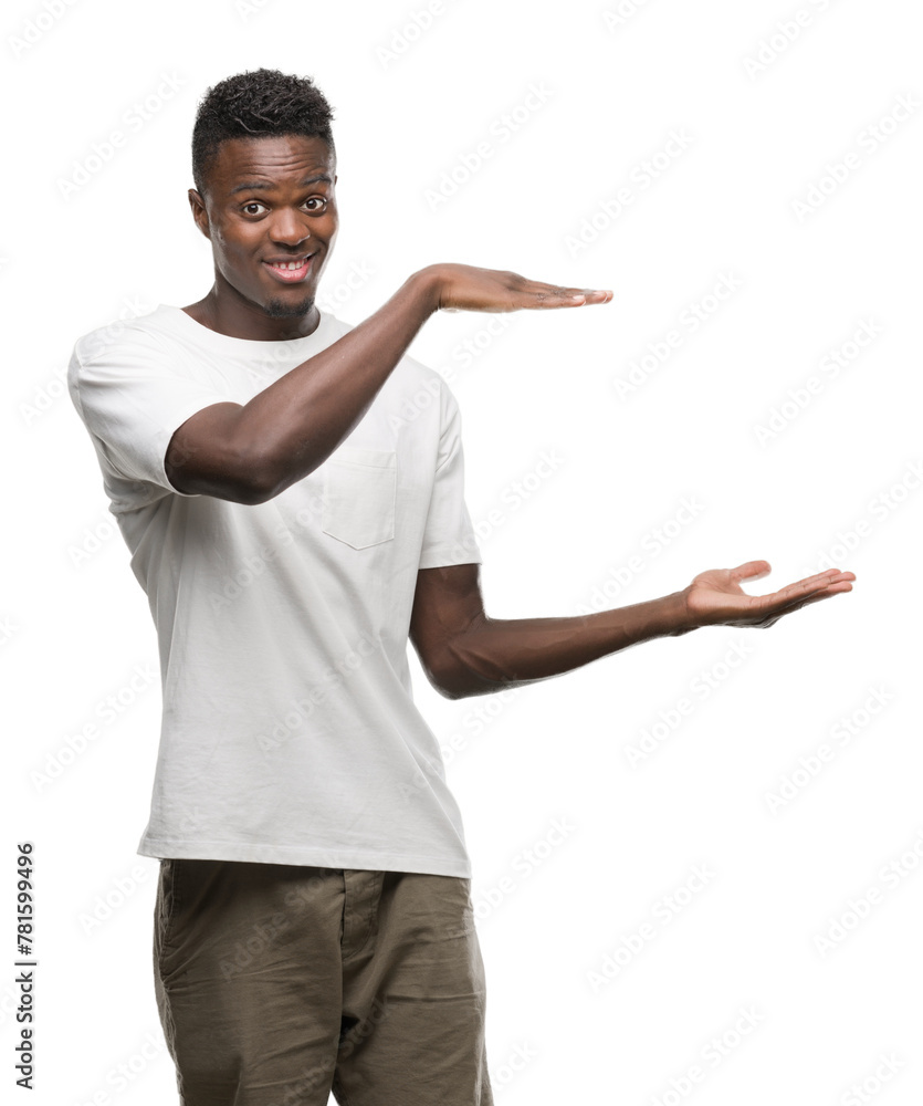 Young african american man wearing white t-shirt gesturing with hands showing big and large size sign, measure symbol. Smiling looking at the camera. Measuring concept. Young african american man wearing white t-shirt gesturing with hands showing big and large size sign, measure symbol. Smiling looking at the camera. Measuring concept.