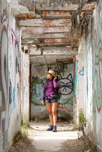  Backpacker woman exploring a ruined house