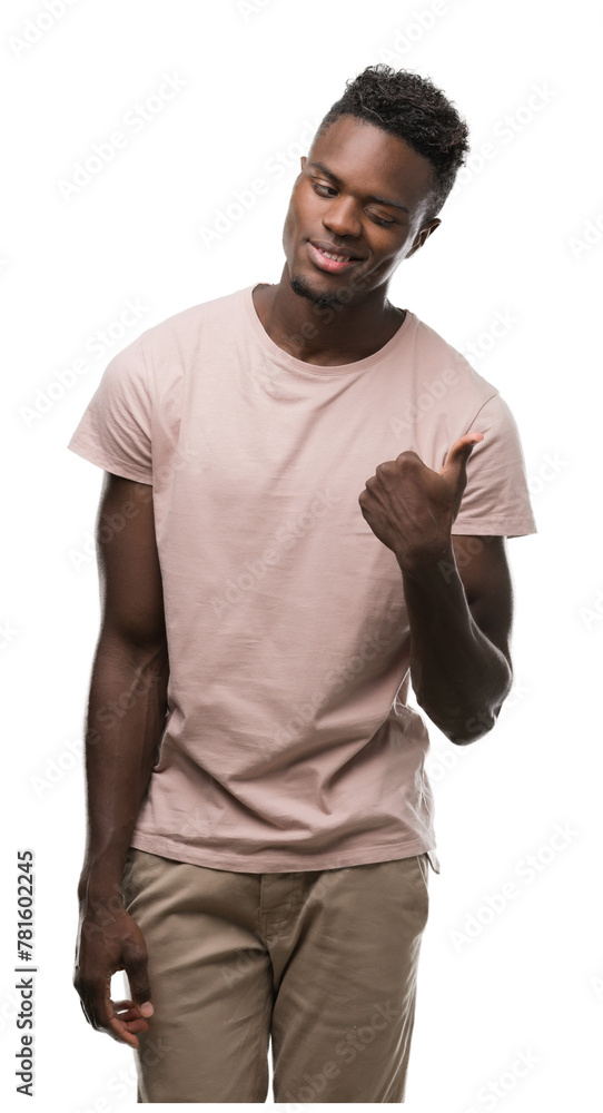 Young african american man pointing with hand and finger up with happy face smiling Young african american man pointing with hand and finger up with happy face smiling