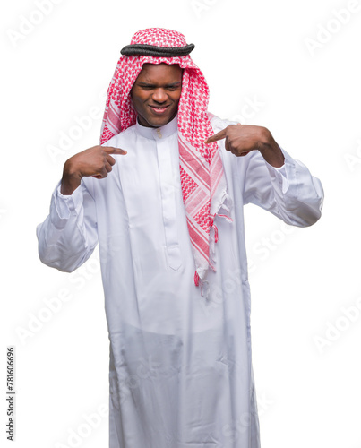 Young arabic african man wearing traditional keffiyeh over isolated background looking confident with smile on face, pointing oneself with fingers proud and happy.