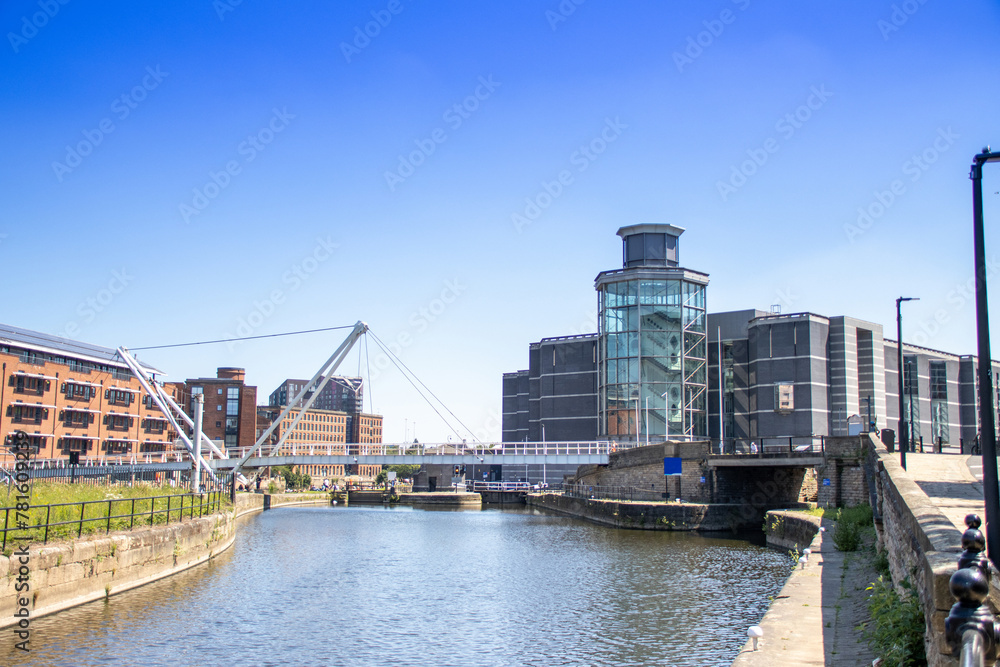 Photo of the Leeds city centre showing the area called The Leeds Dock, along side the canal showing the Royal Armouries Museum and canal with boats.