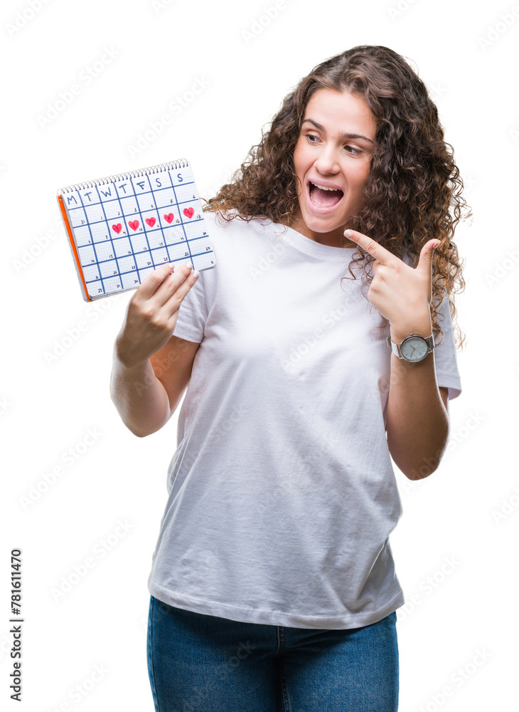 Young brunette girl holding menstruation calendar over isolated background very happy pointing with hand and finger Young brunette girl holding menstruation calendar over isolated background very happy pointing with hand and finger