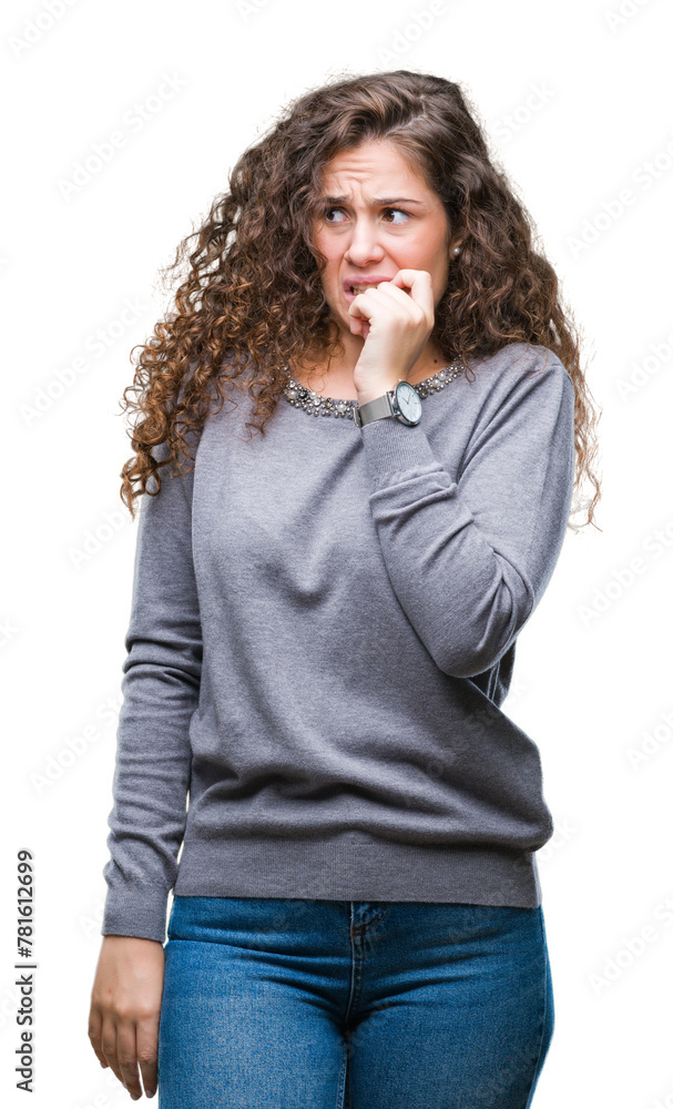 Beautiful brunette curly hair young girl wearing a sweater over isolated background looking stressed and nervous with hands on mouth biting nails. Anxiety problem. Beautiful brunette curly hair young girl wearing a sweater over isolated background looking stressed and nervous with hands on mouth biting nails. Anxiety problem.