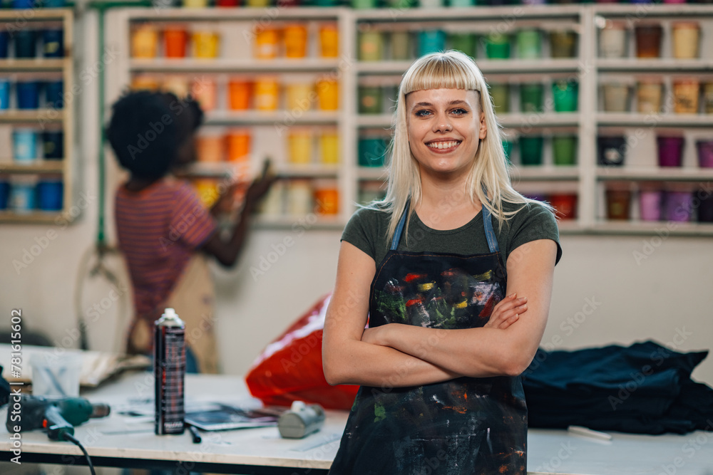 Fototapeta premium Confident print shop entrepreneur with arms folded smiling at the camera