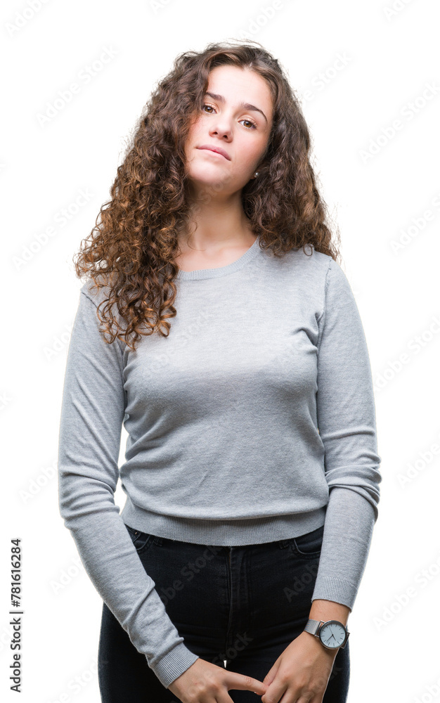 Beautiful brunette curly hair young girl wearing a sweater over isolated background with serious expression on face. Simple and natural looking at the camera. Beautiful brunette curly hair young girl wearing a sweater over isolated background with serious expression on face. Simple and natural looking at the camera.