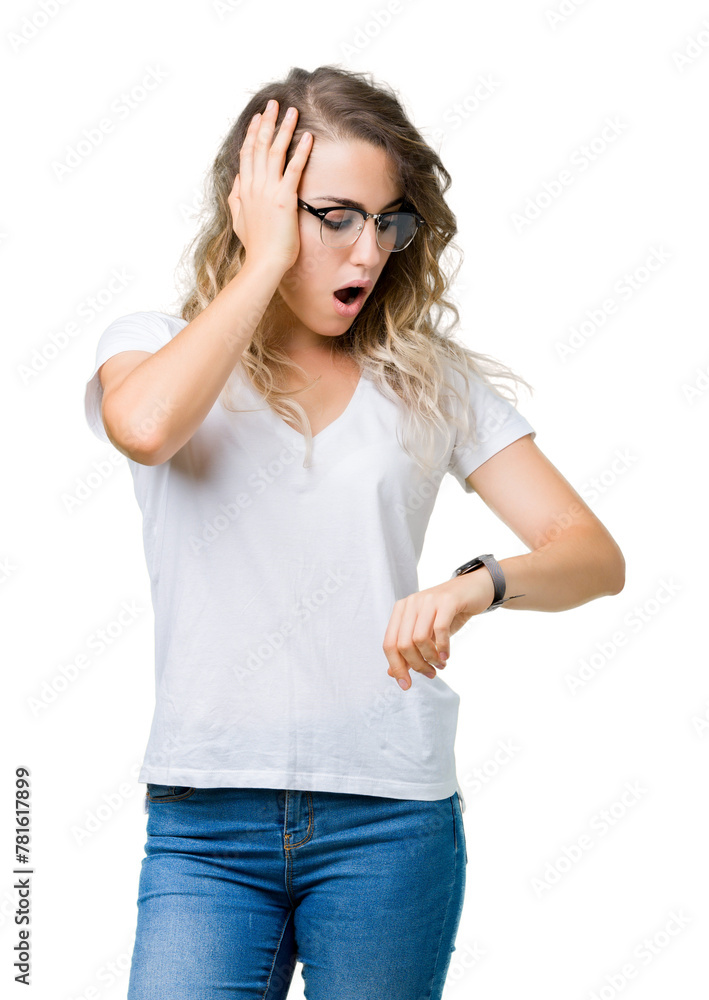 Beautiful young blonde woman wearing glasses over isolated background Looking at the watch time worried, afraid of getting late Beautiful young blonde woman wearing glasses over isolated background Looking at the watch time worried, afraid of getting late