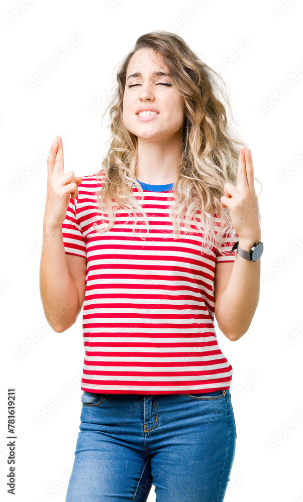 Beautiful young blonde woman over isolated background smiling crossing fingers with hope and eyes closed. Luck and superstitious concept. Beautiful young blonde woman over isolated background smiling crossing fingers with hope and eyes closed. Luck and superstitious concept.