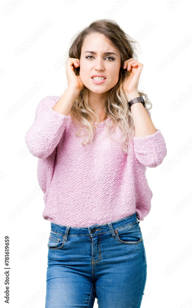 Beautiful young blonde woman over isolated background covering ears with fingers with annoyed expression for the noise of loud music. Deaf concept. Beautiful young blonde woman over isolated background covering ears with fingers with annoyed expression for the noise of loud music. Deaf concept.