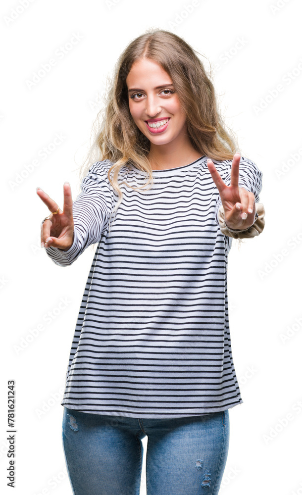 Beautiful young blonde woman wearing stripes sweater over isolated background smiling looking to the camera showing fingers doing victory sign. Number two. Beautiful young blonde woman wearing stripes sweater over isolated background smiling looking to the camera showing fingers doing victory sign. Number two.