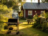 Photograph of grill in the backyard of typical finnish house, nice summer day atmosphere