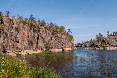 Lake Ladoga and rocky islands. Karelian forest, trees growing on rocks. Ladoga skerries. Nordic Scandinavian landscape