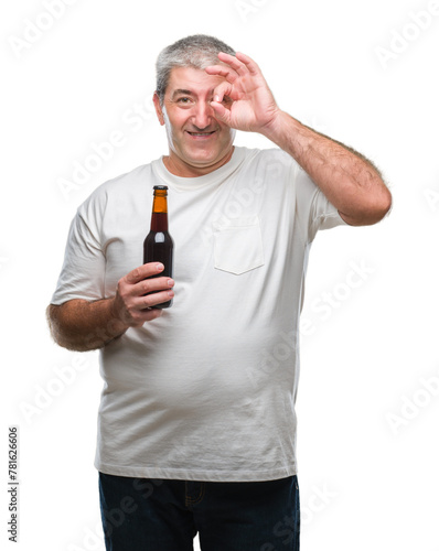 Handsome senior man drinking beer bottle over isolated background with happy face smiling doing ok sign with hand on eye looking through fingers
