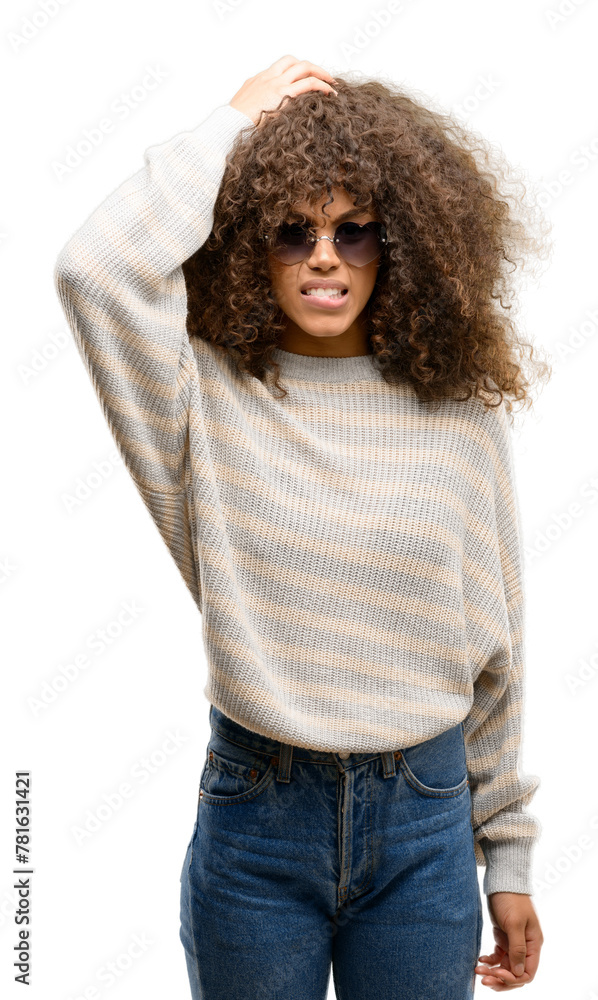 African american woman wearing a stripes sweater stressed with hand on head, shocked with shame and surprise face, angry and frustrated. Fear and upset for mistake. African american woman wearing a stripes sweater stressed with hand on head, shocked with shame and surprise face, angry and frustrated. Fear and upset for mistake.
