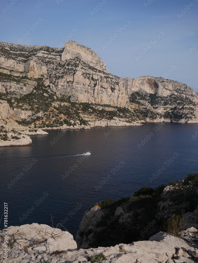 French Calanques in the village of Sormiou, with view of a sailing boat