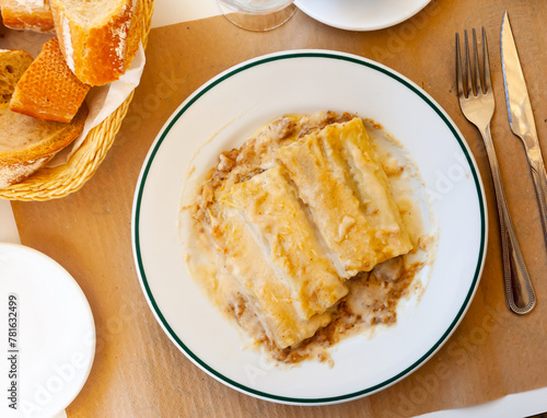 Traditional Italian cannelloni stuffed with minced meat baked in bechamel sauce with grated cheese