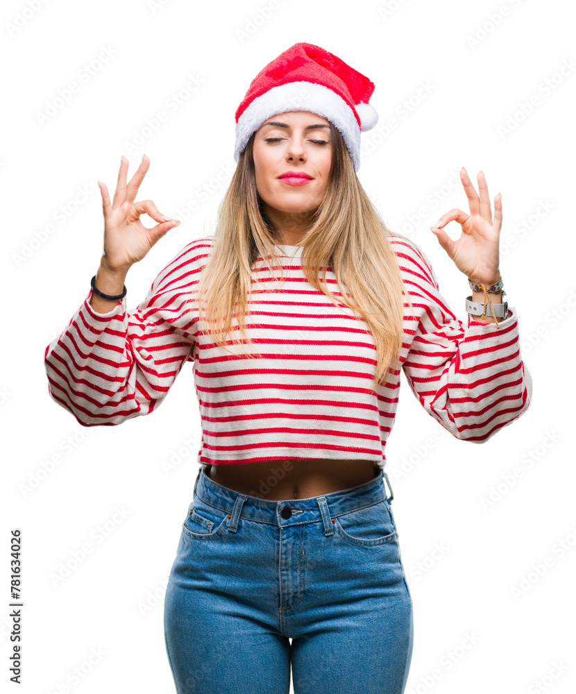 Young beautiful woman wearing christmas hat over isolated background relax and smiling with eyes closed doing meditation gesture with fingers. Yoga concept. Young beautiful woman wearing christmas hat over isolated background relax and smiling with eyes closed doing meditation gesture with fingers. Yoga concept.