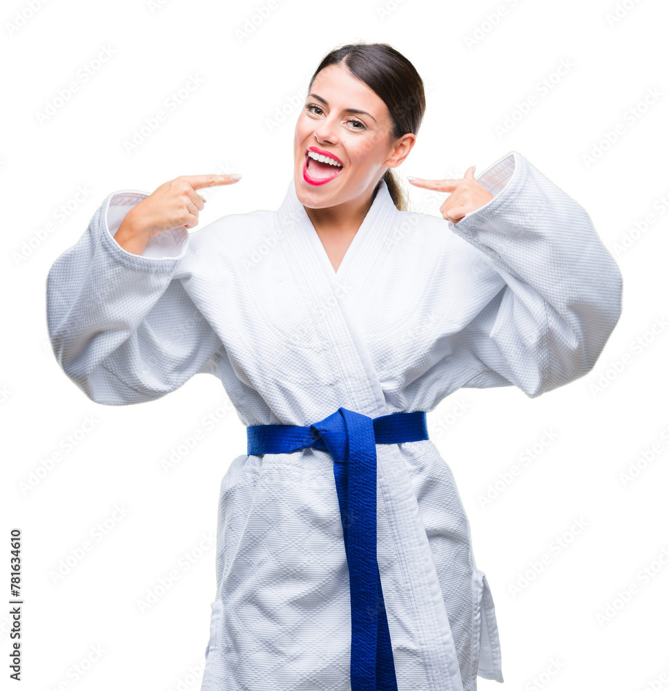 Young beautiful woman wearing karate kimono uniform over isolated background smiling confident showing and pointing with fingers teeth and mouth. Health concept.