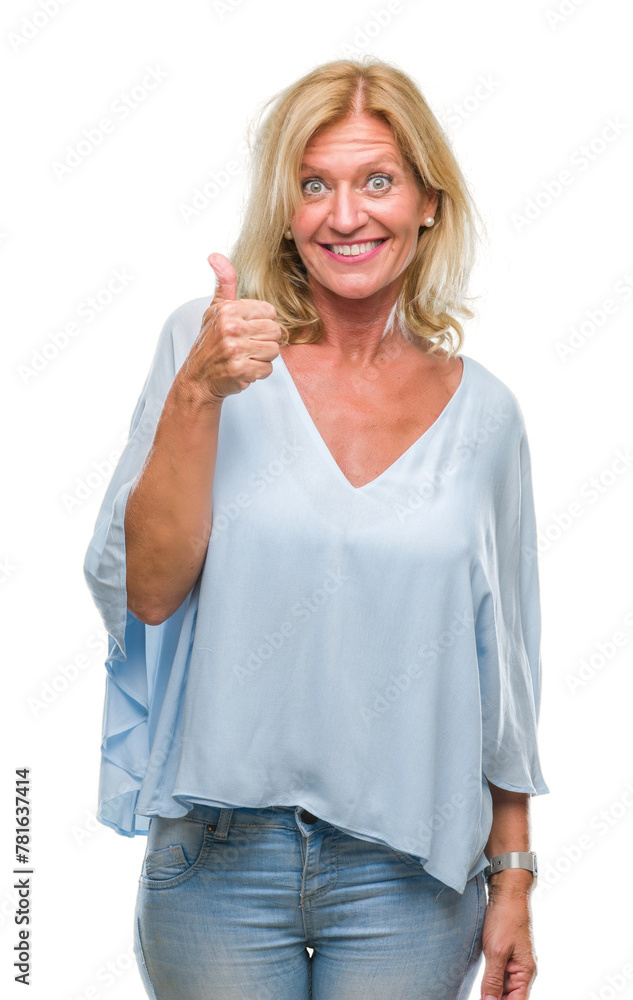Middle age blonde business woman over isolated background doing happy thumbs up gesture with hand. Approving expression looking at the camera with showing success. Middle age blonde business woman over isolated background doing happy thumbs up gesture with hand. Approving expression looking at the camera with showing success.