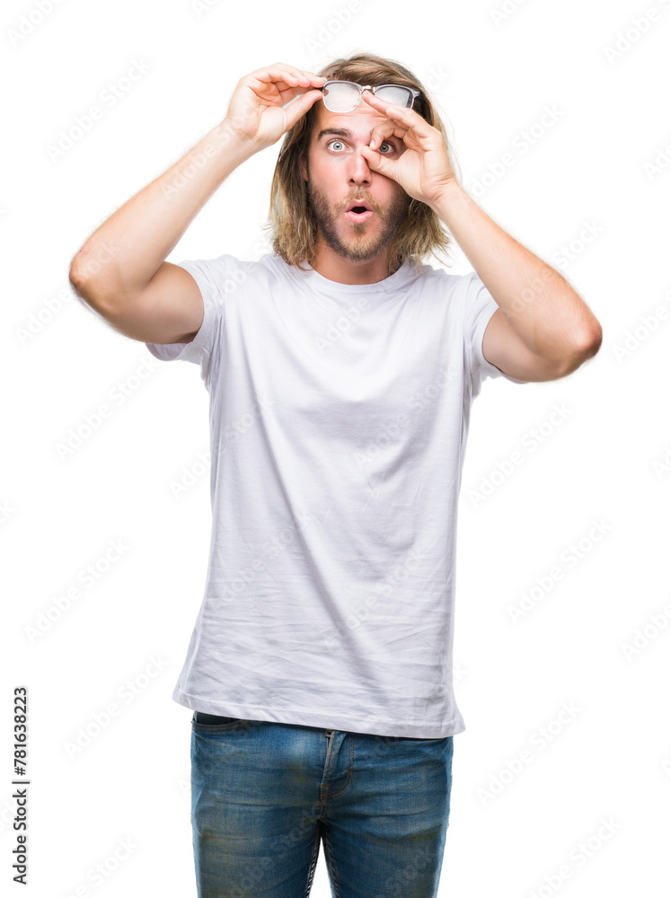 Young handsome man with long hair wearing glasses over isolated background doing ok gesture shocked with surprised face, eye looking through fingers. Unbelieving expression. Young handsome man with long hair wearing glasses over isolated background doing ok gesture shocked with surprised face, eye looking through fingers. Unbelieving expression.