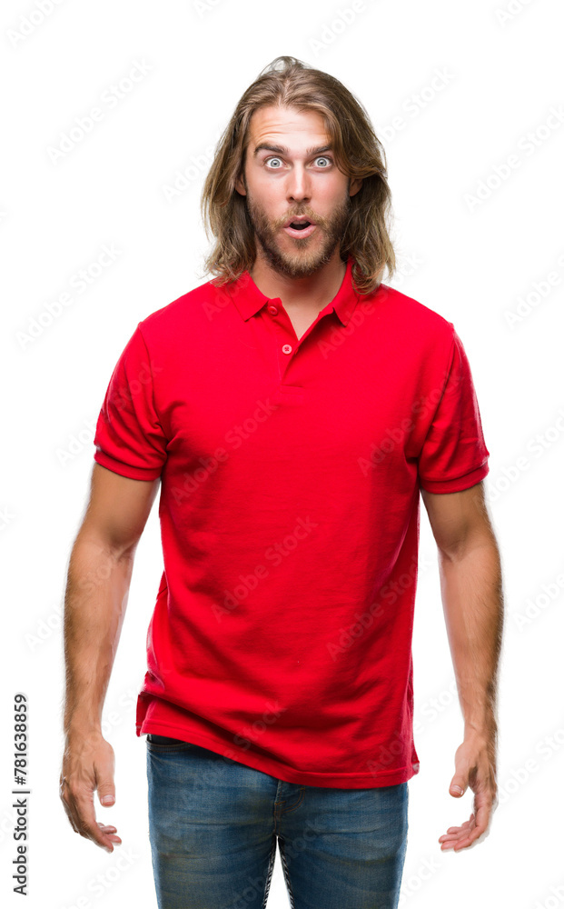 Fototapeta premium Young handsome man with long hair over isolated background afraid and shocked with surprise expression, fear and excited face.