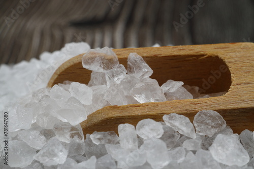 sea salt in a spoon isolated on black background photo