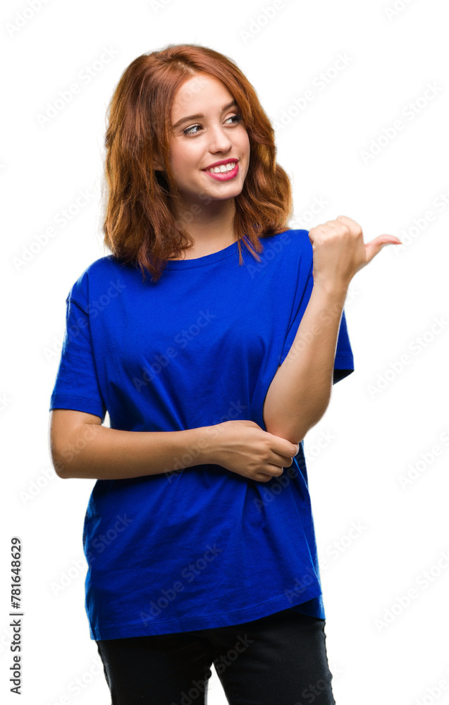 Young beautiful woman over isolated background smiling with happy face looking and pointing to the side with thumb up. Young beautiful woman over isolated background smiling with happy face looking and pointing to the side with thumb up.