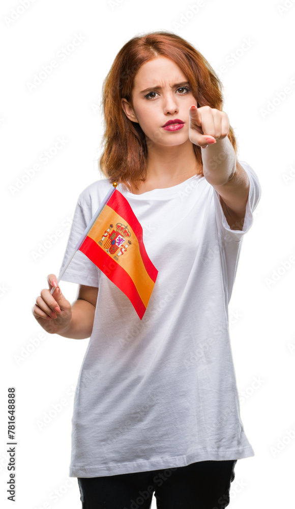 Young beautiful woman holding flag of spain over isolated background pointing with finger to the camera and to you, hand sign, positive and confident gesture from the front Young beautiful woman holding flag of spain over isolated background pointing with finger to the camera and to you, hand sign, positive and confident gesture from the front