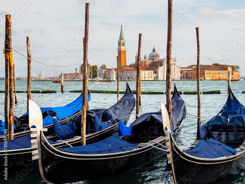 Gondolas moored by Saint Mark square with San Giorgio di Maggiore church in Venice, Italy